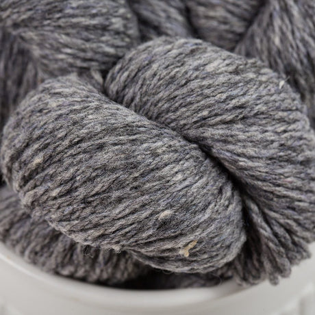 Gray skein of yarn in a white container