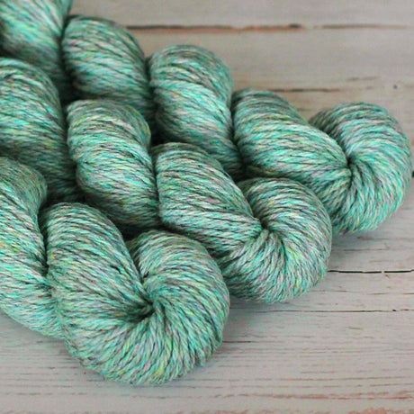 Turquoise skein of yarn on a wooden surface