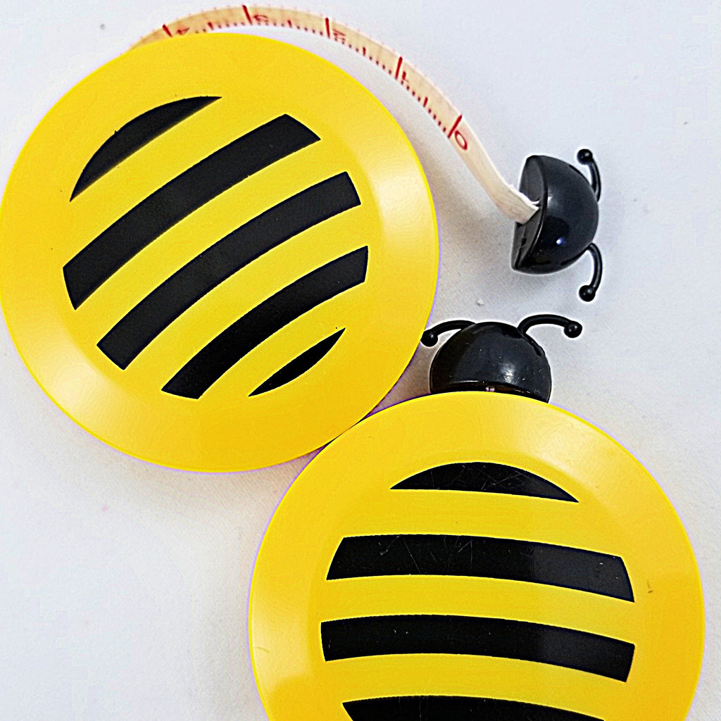 Cute, yellow tape measure shaped like a bee.