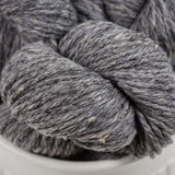 Gray skein of yarn in a white container
