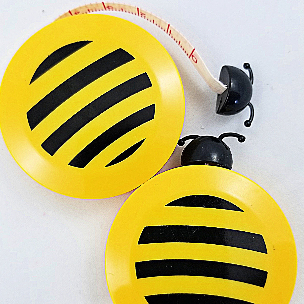 Cute, yellow tape measure shaped like a bee.